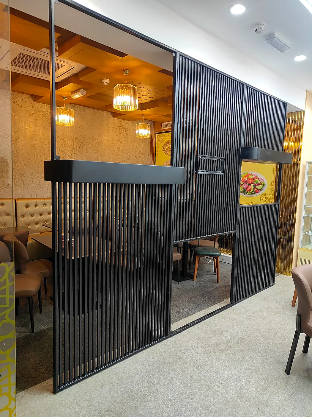 Black steel slatted partition for a restaurant