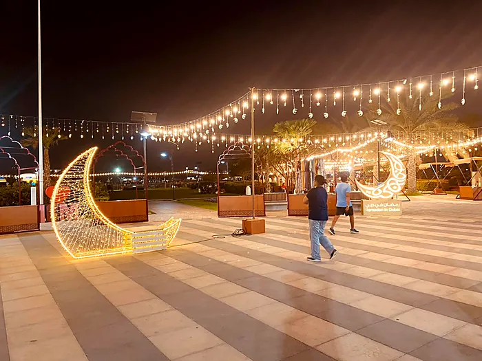Illuminated crescent arches at a seaside festival