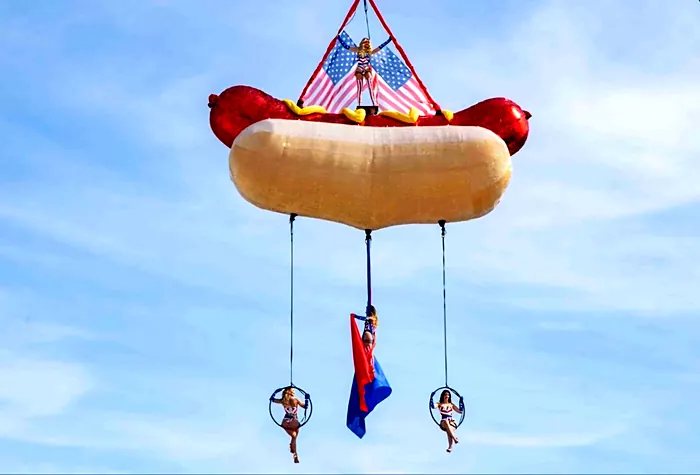 Giant hotdog aerial prop flown above a beach club