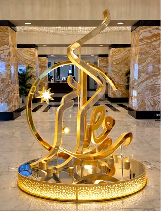 Gold calligraphy sculpture in a hotel lobby