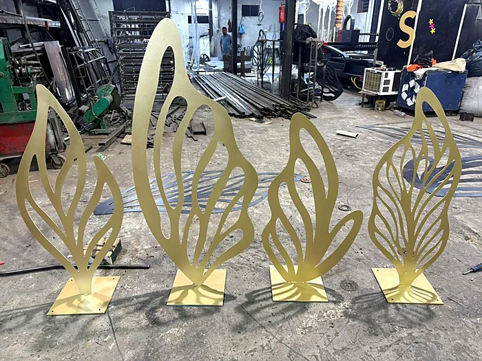 Gold leaf sculptures cut from steel sheet