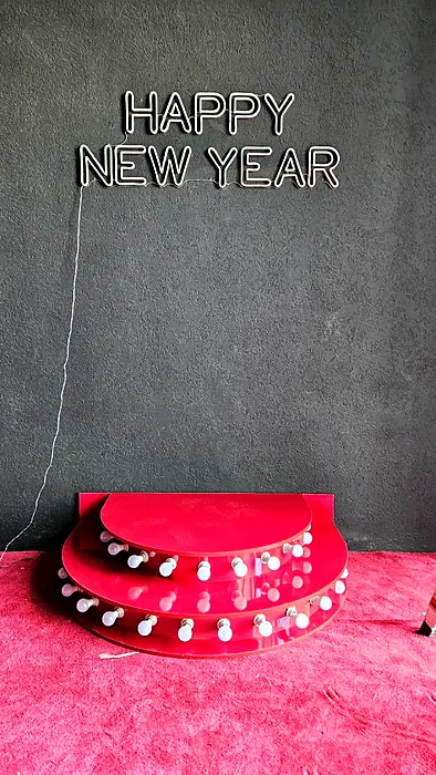 Happy New Year neon sign with stage riser