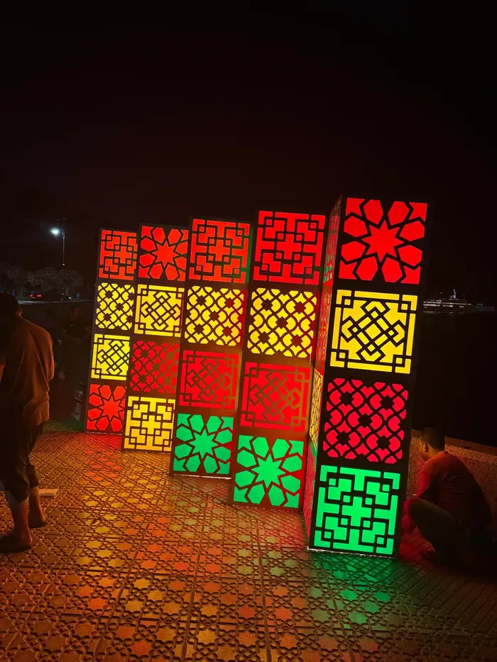 Backlit columns with cut Islamic patterns
