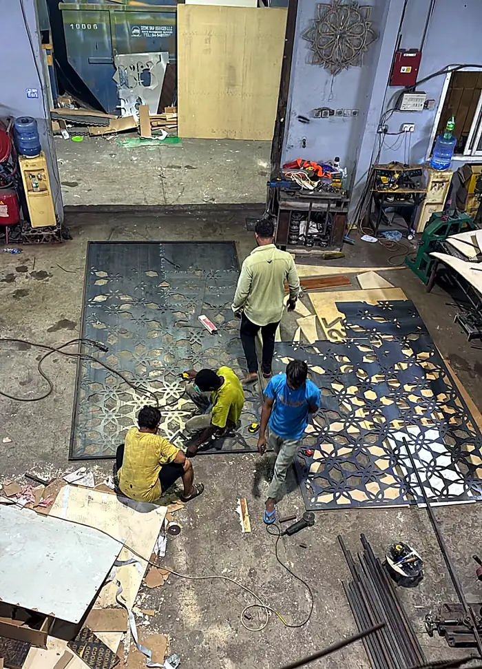 Laser-cut pattern panels being assembled