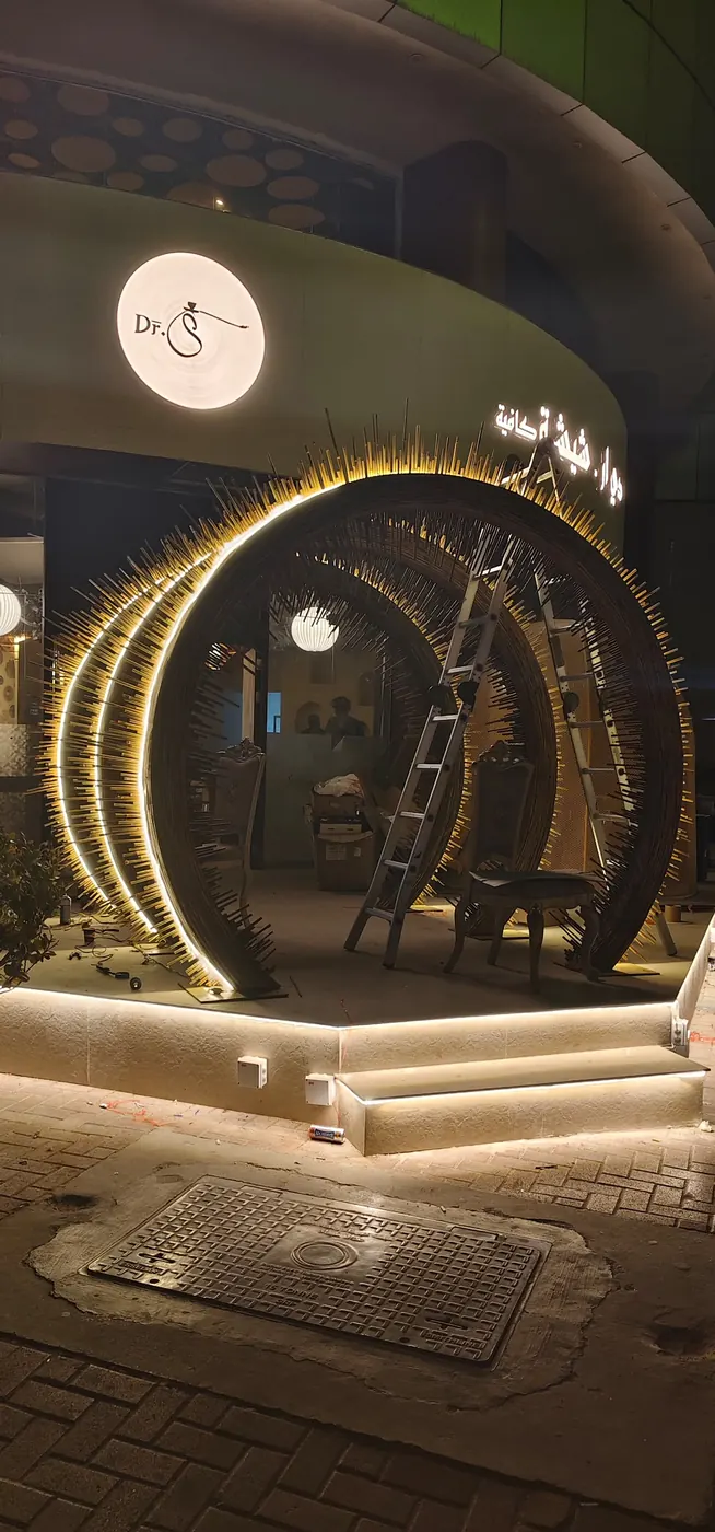 Layered spike arch entrance with LED lighting