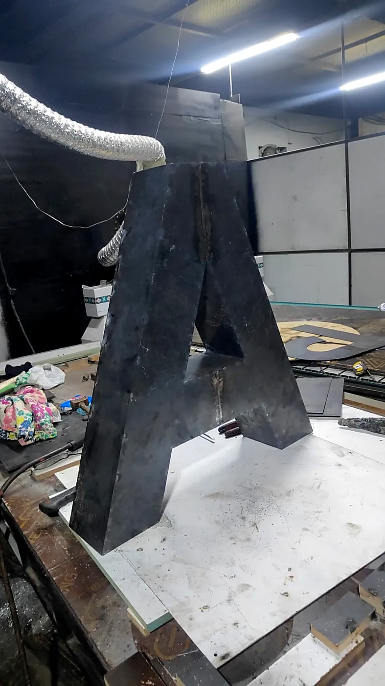 Steel letter with our CNC router behind